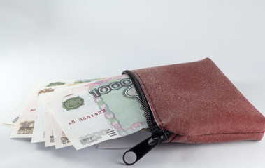Russian ruble in a leather bag on a white background.