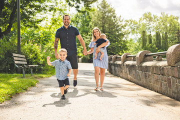 Fototapeta premium Happy family having fun resting in park
