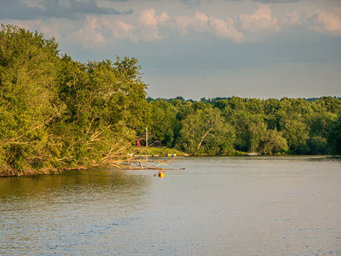 lone kayaker on river at sunset