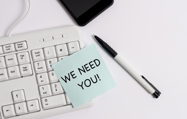 Handwriting text writing We Need You. Conceptual photo asking someone to work together for certain job or target White pc keyboard with empty note paper above white background