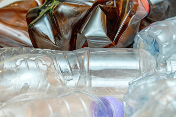 Lot of used plastic, crumpled empty bottles, packets, pollution recycle eco concept background close up selective focus