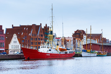 old fire ship in Lübecker oldtimer harbor with Obertrave river and city view