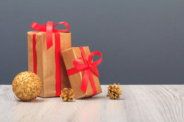 Gift boxes and toy ball on gray background