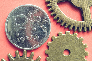 gear cog and the Russian ruble on a pink background