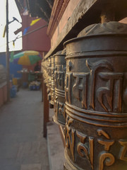 Fototapeta premium Praying wheels at Buddhist temple Swayambhunath known as Monkey temple. Kathmandu, Nepal