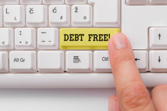 Word writing text Debt Free. Business photo showcasing does not owning any money or things to any individual or companies White pc keyboard with empty note paper above white background key copy space