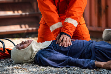 Medium shot of firefighter in fire suit on safety rescue duty help stop breathing heart attack man...