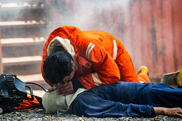 Medium shot of firefighter in fire suit on safety rescue duty help stop breathing heart attack man...
