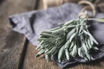 A bunch of fresh sage on a wooden table