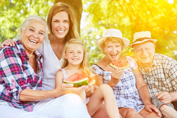 Extended family eating melon in summer