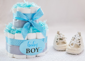 Present cake with diapers for newborn baby boy