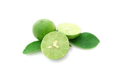 Fototapeta na wymiar green lemon with leaves isolated on white 