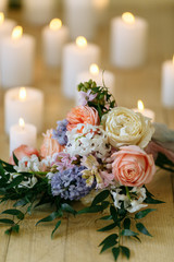 wedding bouquet on the floor with many candles