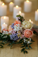 wedding bouquet on the floor with many candles