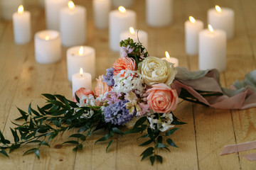 wedding bouquet on the floor with many candles