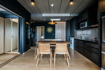 Stylish kitchen interior with dining table and chairs