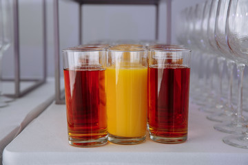 glasses of juice and empty glasses for wine