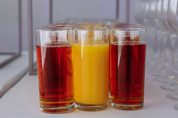 Fototapeta na wymiar glasses of juice and empty glasses for wine