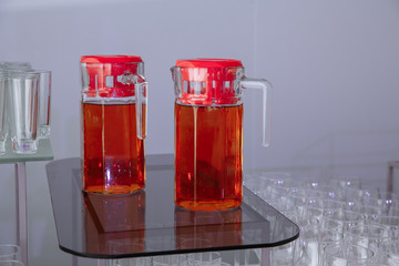 glasses of juice and empty glasses for wine