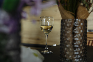 glass of white wine in perspective with blurry background