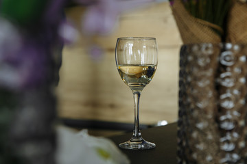 glass of white wine in perspective with blurry background