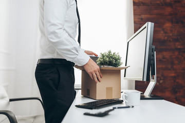 Businessman clearing his desk after being made redundant