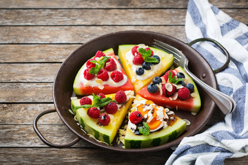 Watermelon pizza with berries, fruits, yogurt, feta cheese