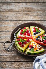 Watermelon pizza with berries, fruits, yogurt, feta cheese