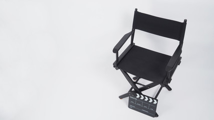 Black Clapper board or movie slate with director chair use in video production or movie and cinema industry. It's put on white background.