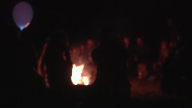 Friends having fun on the campfire. Young peoples Silhouettes sitting around campfire, romantic having rest friends girls boy woman man. Bonfire, camping silence calm summer holidays warm