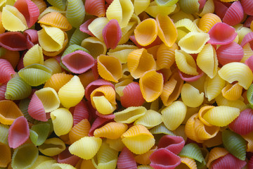 Colored uncooked macaroni as background