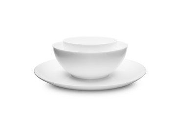 Set of white dishes on table on light background.