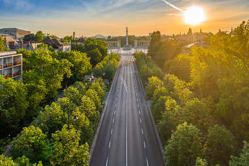 Budapest, Hungary - Aerial drone view of Andrassy street at sunrise with Heroes' Square (Hosok tere) at background at summer time - obrazy, fototapety, plakaty