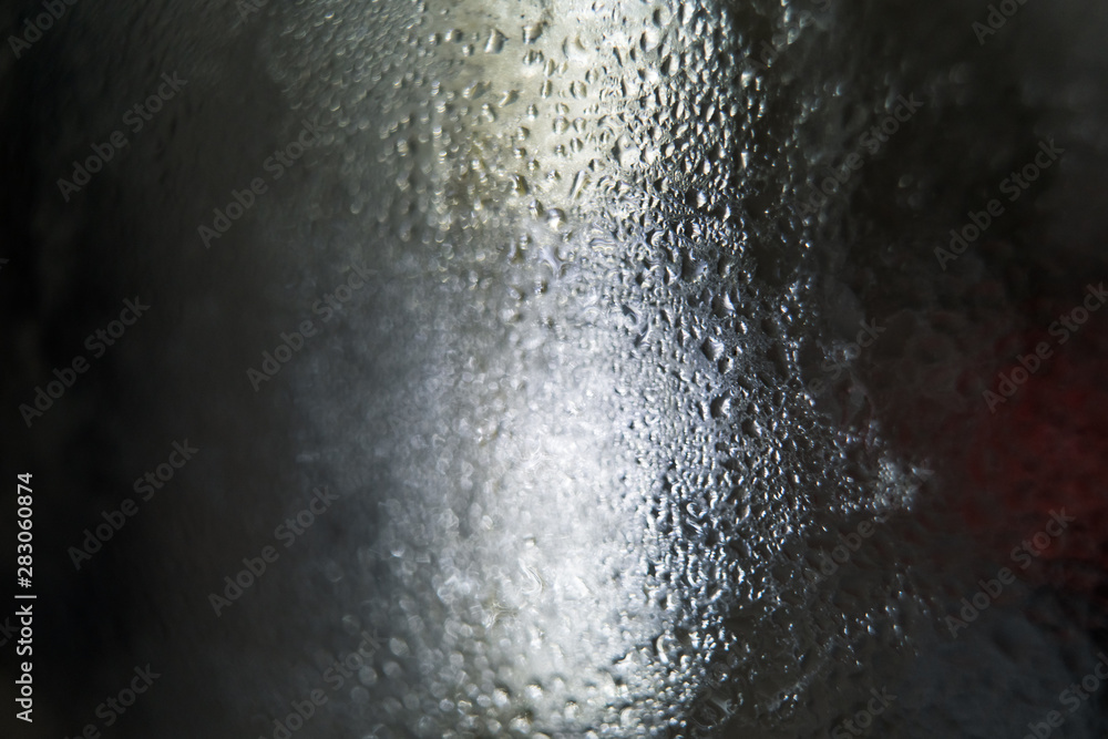 Aufkleber blurred drops of rain on window building with abstract lights, water drop on glass window