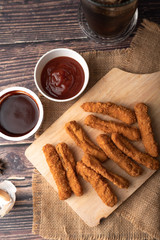 Hot and spicy Korean barbeque fried chicken on wood cutting board