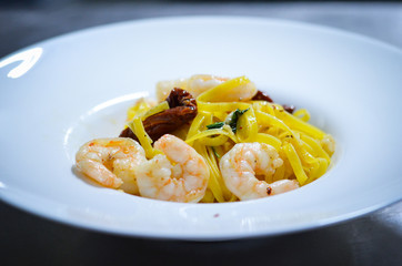 italian sea food pasta dish with fresh vegetables, squid, octopus, shells & garlic