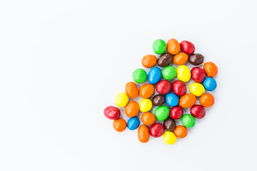 Candy lying on white background. Bright and Colorful sweets top view. Flat lay image. Copy space template. Unhealthy eating concept