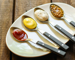 sauce (different types of sauces in a spoon) portion serving. top food background. copy space