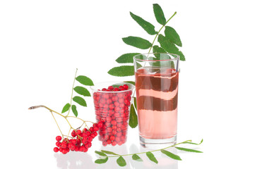 Glass with juice and branches ashberry on white background
