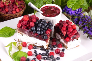 Cake with cream and fresh raspberries and blueberries useful delicacy