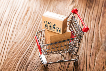 shopping online at home concept.Cartons in a shopping cart on a laptop keyboard.online shopping is...