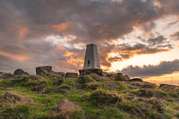 Trig point on top of The Roaches at sunset in the Peak District National Park.