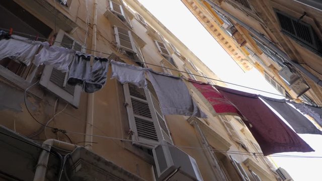 From Down to Up Shot Apartment Builidings in Alley. Street with palace in a neighborhood. Old quarter with Clothes dry between the facedes..