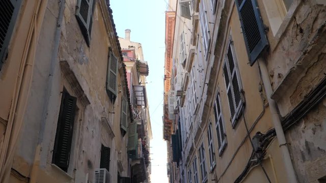 From Down to Up Shot Apartment Builidings in Alley . Old quarter with demaged facede in European Street with palace in characteristic neighborhood.