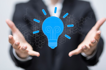  holding illuminated light bulb, idea, innovation and inspiration concept.