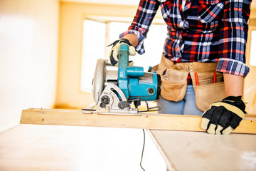 A woman worker in the carpenter workroom renovation