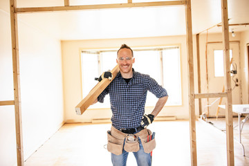 A man worker in the carpenter workroom renovation wolding wood