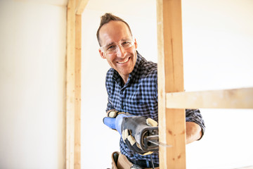 A man worker in the carpenter workroom renovation