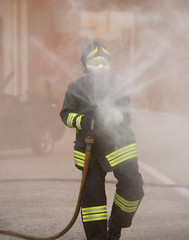 firefighter in action with the foaming agent during an emergency