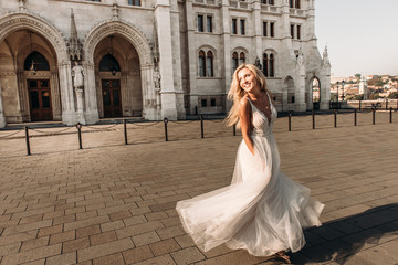 Obraz premium A beautiful bride in the white wedding dress